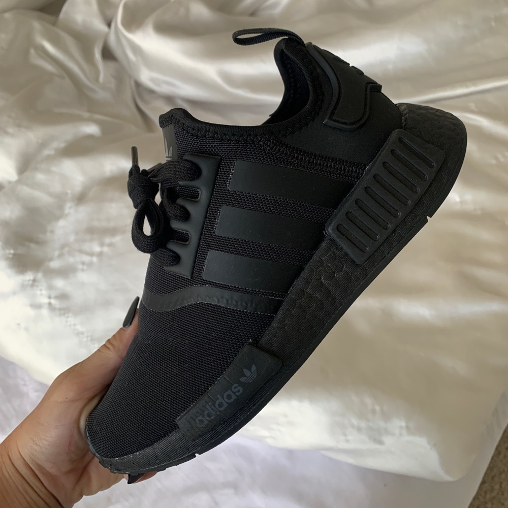 All black Adidas NMDs